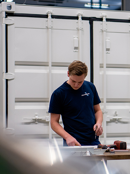 Collega aan het werk bij één van de batterijcontainers.